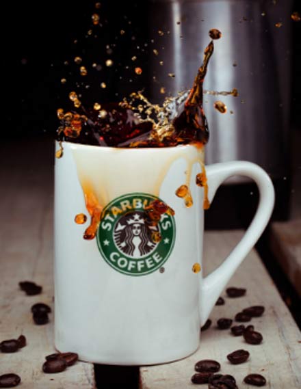 Starbucks Mug Full of Coffee Beans · Free Stock Photo